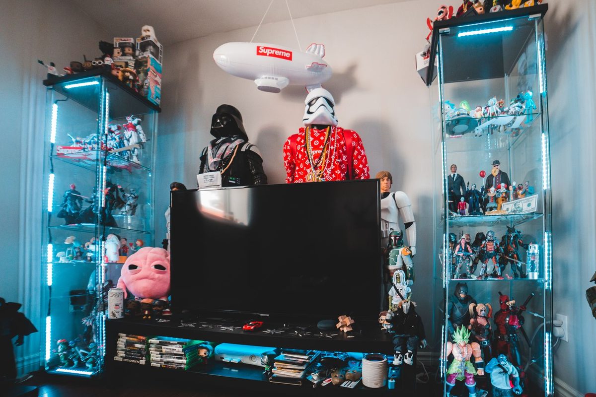 Meuble télé entouré de vitrines remplies de figurines de collection